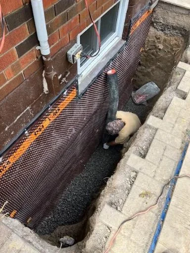 Foundation waterproofing membrane and drainage board installation on a Surrey home