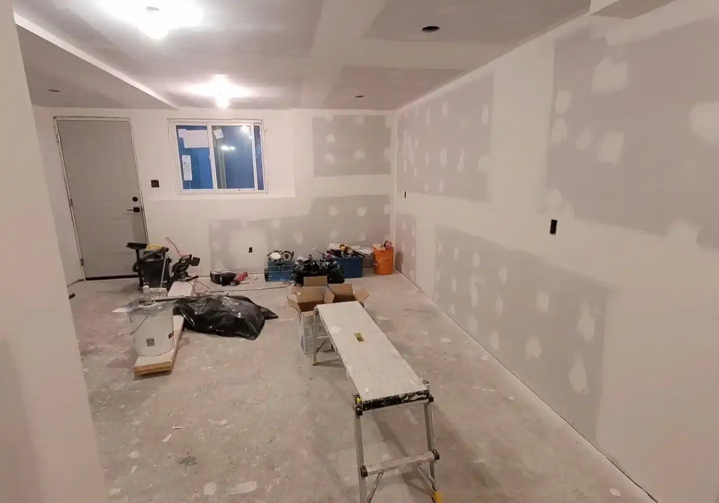 Drywall ceiling seam being repaired and finished smooth