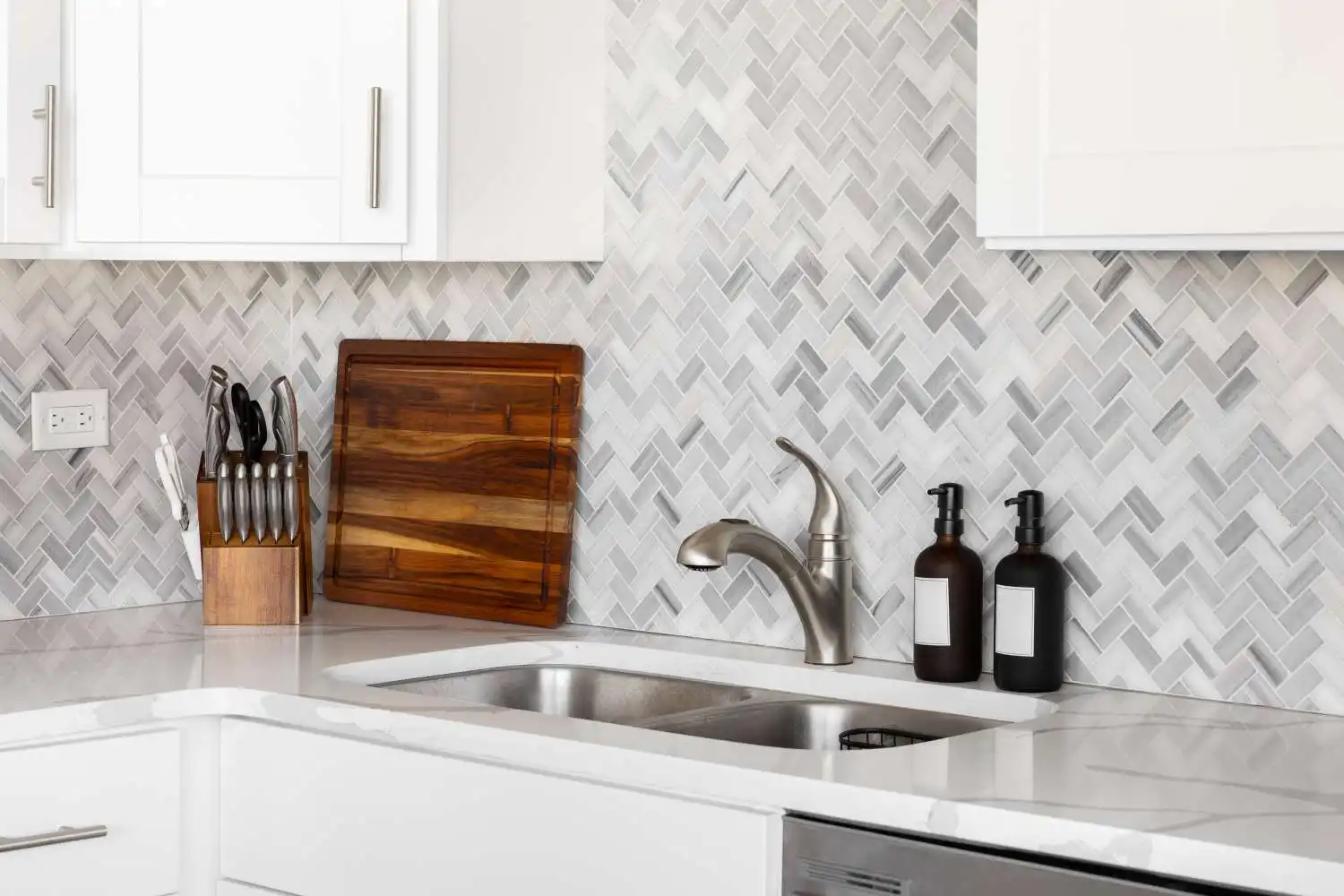 Tile kitchen backsplash installed behind the countertop and cabinets in a Surrey home